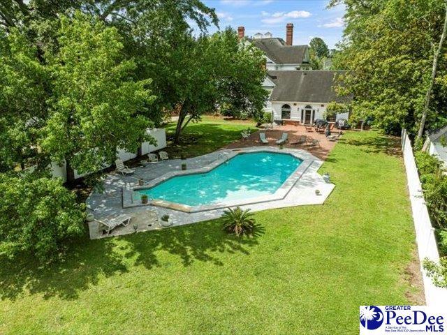 view of pool featuring a yard and a patio area