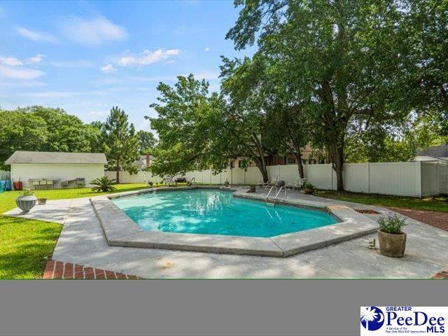 view of swimming pool with a yard and a patio area