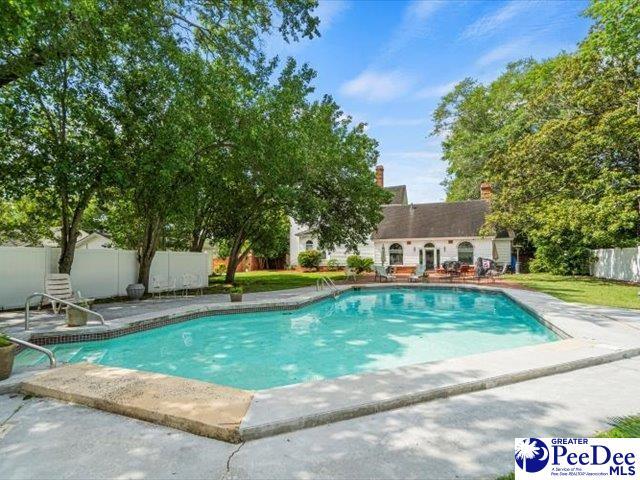 view of pool with an outbuilding and a patio area