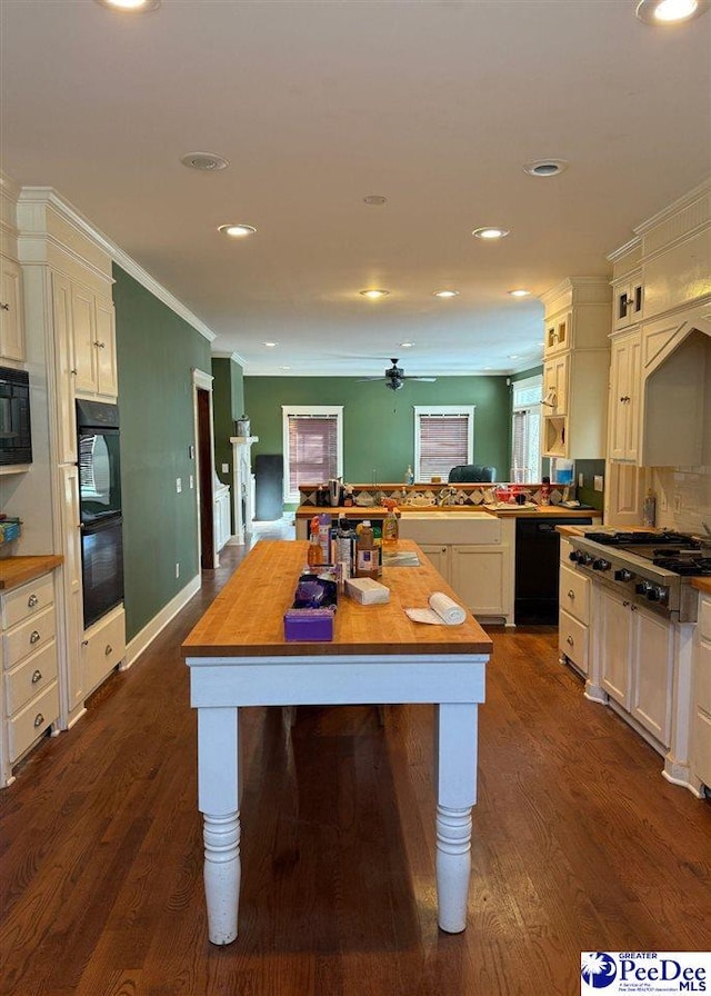 kitchen featuring recessed lighting, dark wood-type flooring, backsplash, black appliances, and crown molding