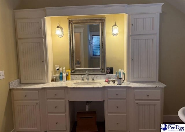 bathroom featuring vanity and baseboards