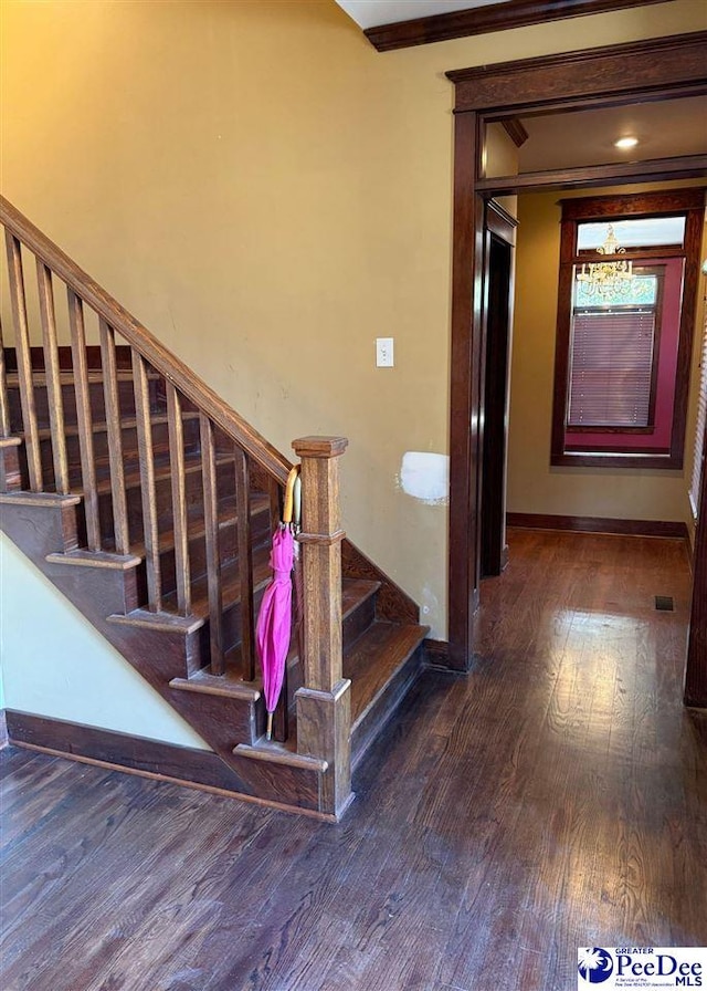 stairway with baseboards and wood finished floors