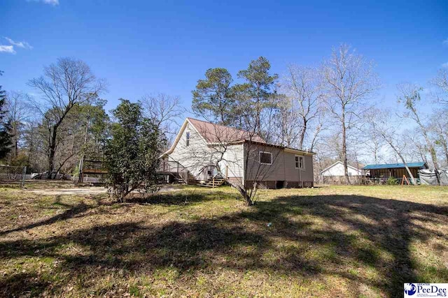 view of property exterior with a lawn