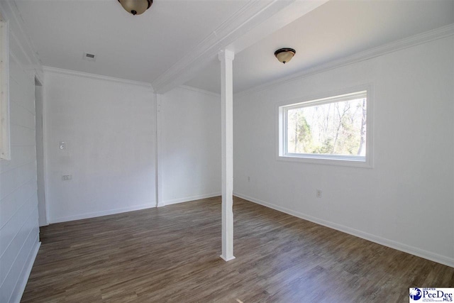 unfurnished bedroom with baseboards, ornate columns, wood finished floors, and crown molding