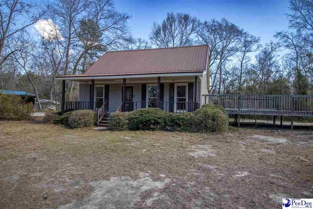 view of front of house with covered porch and metal roof