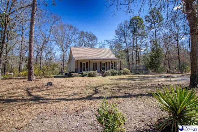 view of front of property featuring covered porch and metal roof