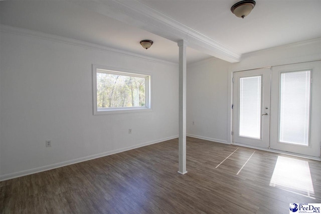 spare room with baseboards, ornamental molding, wood finished floors, and french doors