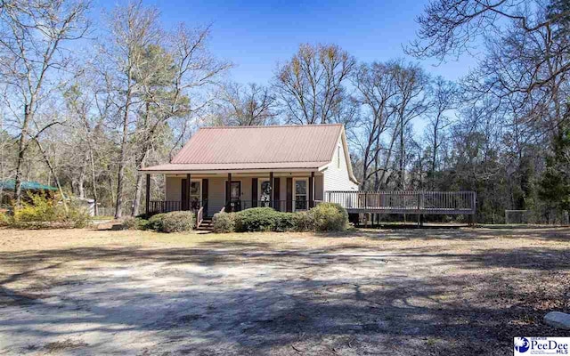 view of front of house featuring covered porch and metal roof