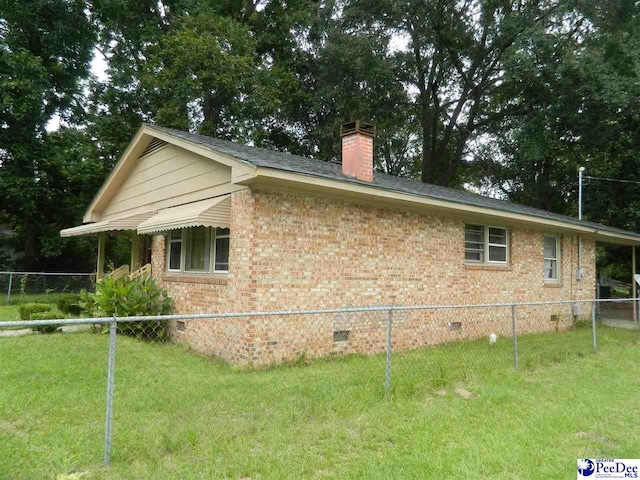 view of side of home with a lawn