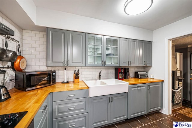 500UNIT31 Woodland, Florence, SC 29501 - kitchen with gray cabinets, butcher block counters, stainless steel microwave, and backsplash