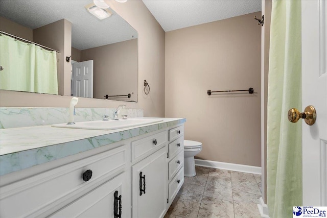 bathroom with toilet, baseboards, a textured ceiling, and vanity