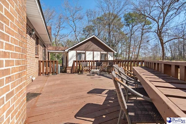 wooden terrace with outdoor dining space