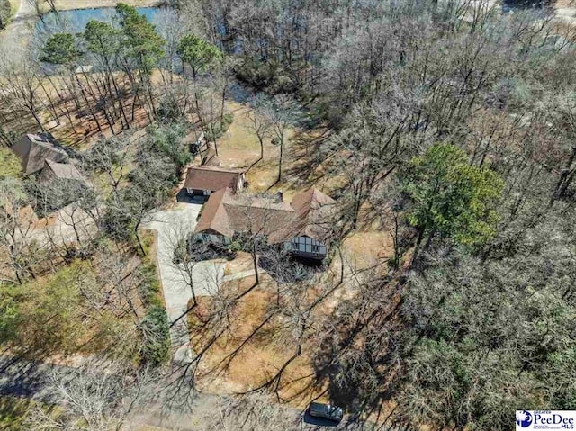 drone / aerial view featuring a wooded view