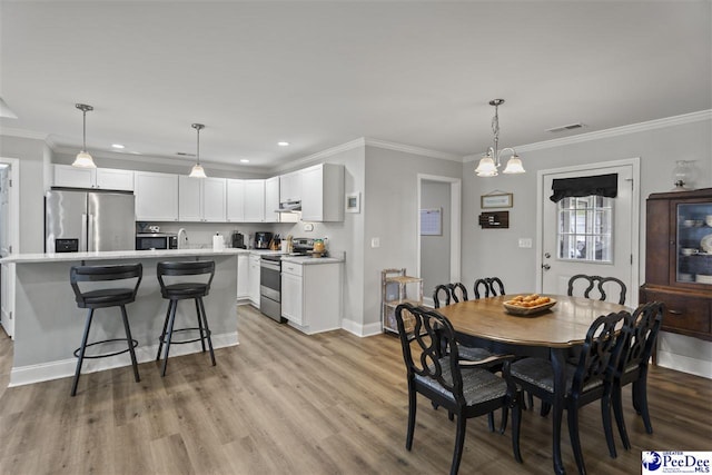 515 Young St, Darlington, SC 29532 - dining area with light wood-style floors, baseboards, ornamental molding, and recessed lighting