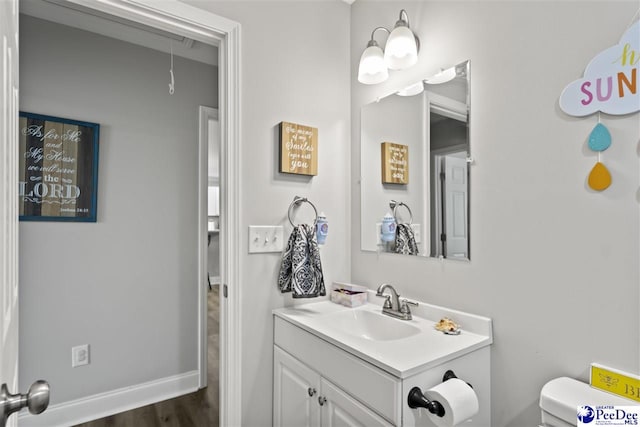 515 Young St, Darlington, SC 29532 - half bath featuring toilet, vanity, wood finished floors, and baseboards