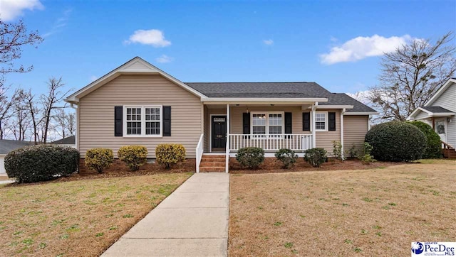 view of front facade with a front yard and covered porch