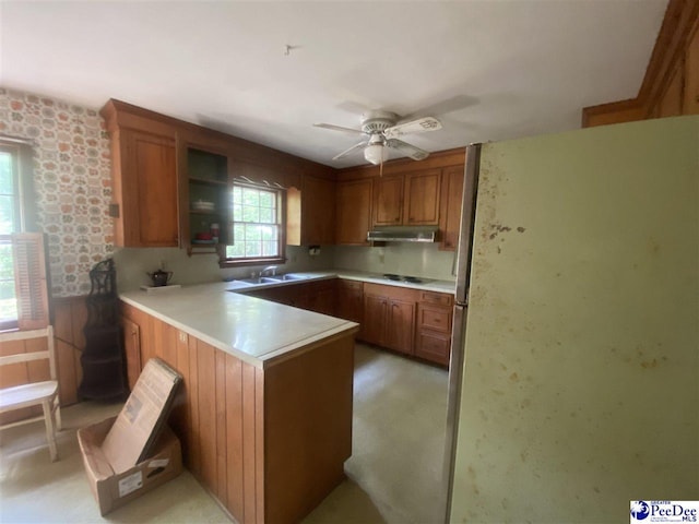 112 Williamson Pl, Darlington, SC 29532 - kitchen featuring freestanding refrigerator, a peninsula, brown cabinetry, and under cabinet range hood