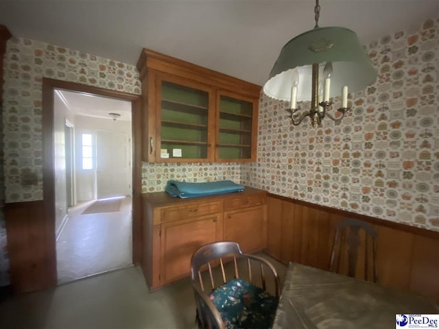 112 Williamson Pl, Darlington, SC 29532 - dining space featuring wainscoting, finished concrete flooring, and a chandelier