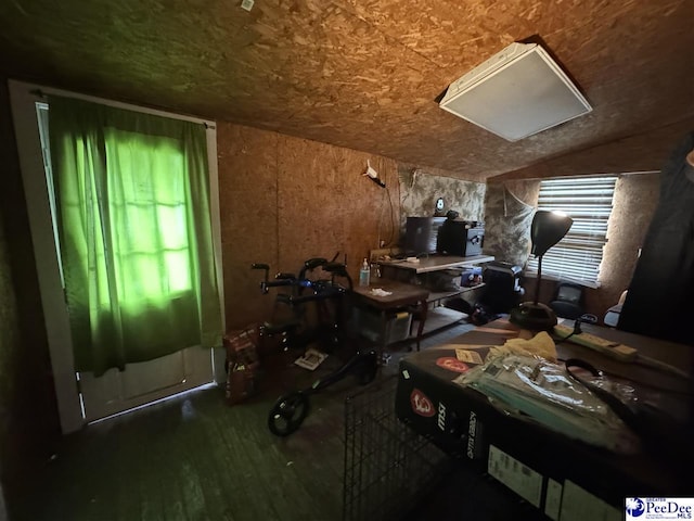 misc room featuring wood finished floors and vaulted ceiling