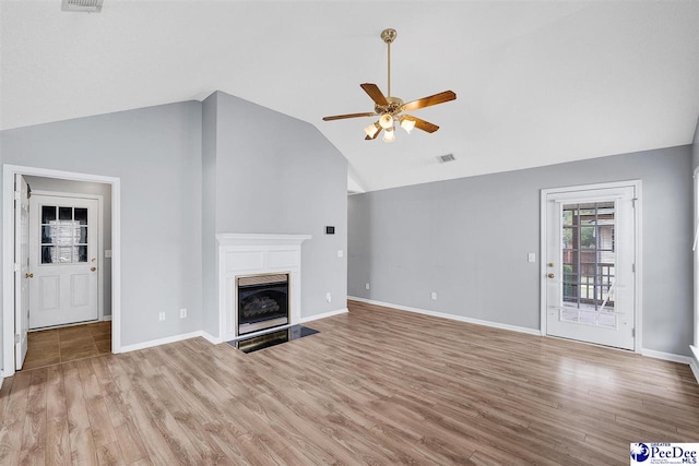 unfurnished living room with vaulted ceiling, ceiling fan, and light hardwood / wood-style floors