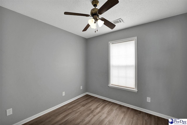 empty room featuring hardwood / wood-style floors, a textured ceiling, and ceiling fan