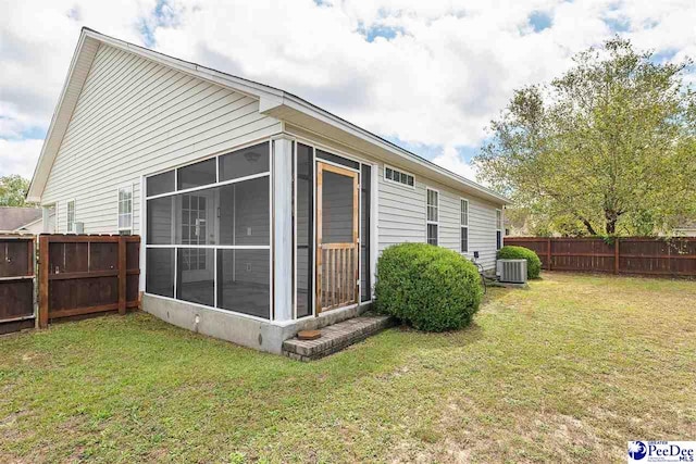 view of home's exterior featuring a sunroom and a yard