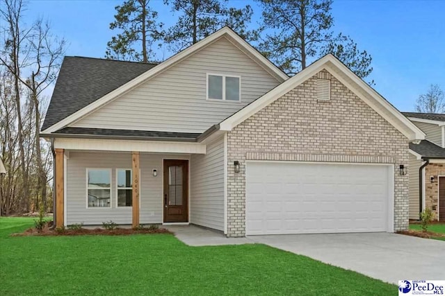 view of front of property featuring a garage and a front yard