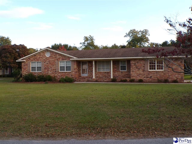 ranch-style home featuring a front yard