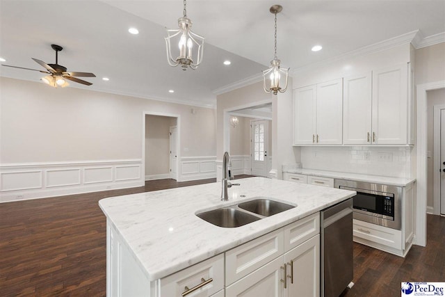 kitchen featuring stainless steel appliances, sink, a center island with sink, and white cabinets