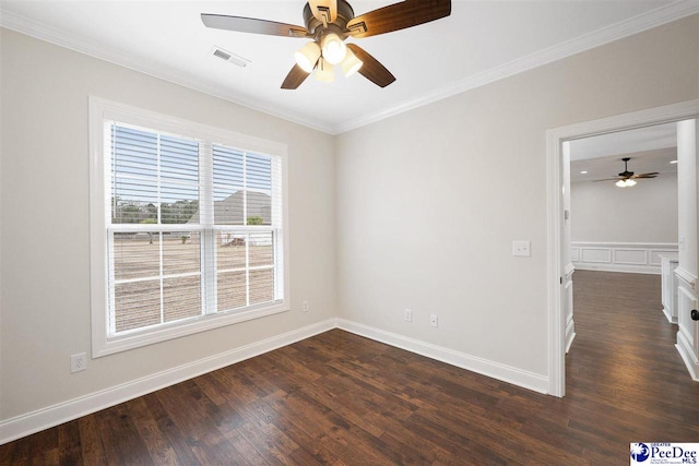 spare room featuring ornamental molding and dark hardwood / wood-style floors