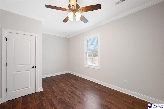 spare room with ceiling fan, ornamental molding, and dark hardwood / wood-style floors