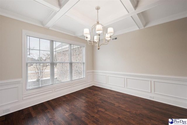 unfurnished room featuring hardwood / wood-style flooring, coffered ceiling, a chandelier, and beamed ceiling