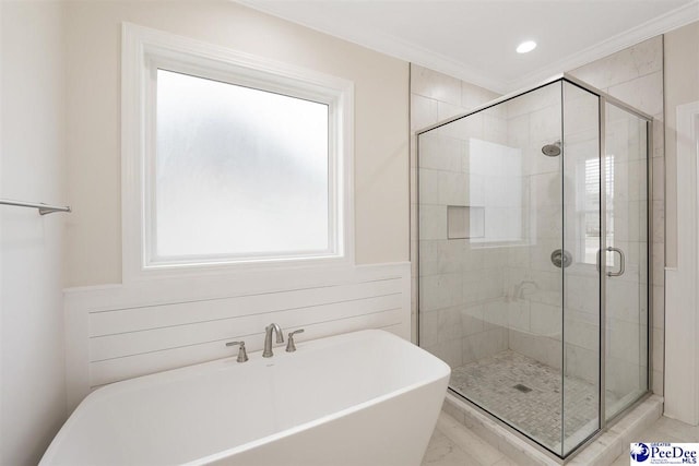 bathroom featuring crown molding, separate shower and tub, and sink