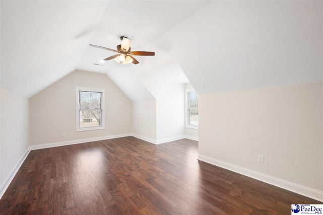 bonus room with lofted ceiling, dark hardwood / wood-style floors, and ceiling fan