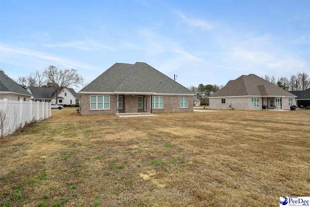 rear view of house with a lawn