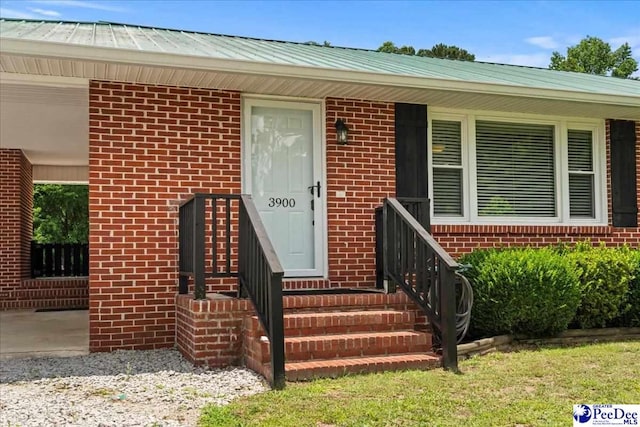 3900 Claussen Rd, Florence, SC 29505 - property entrance featuring brick siding and a metal roof
