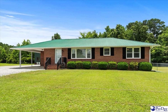 3900 Claussen Rd, Florence, SC 29505 - single story home with driveway, a metal roof, an attached carport, entry steps, and brick siding