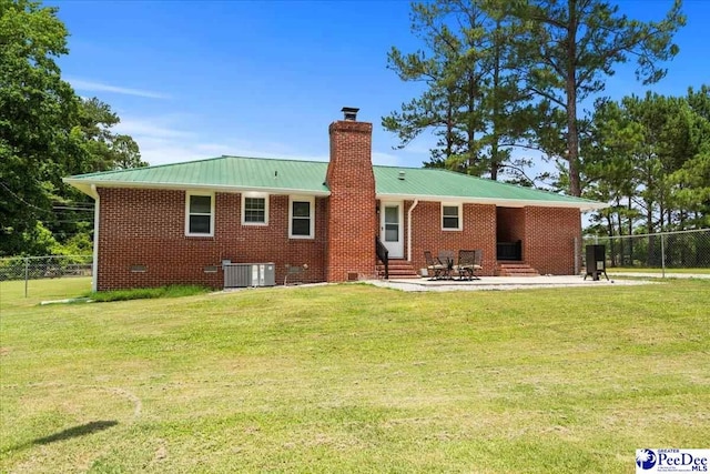 3900 Claussen Rd, Florence, SC 29505 - back of property featuring a chimney, brick siding, a patio, entry steps, and a metal roof