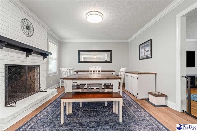3900 Claussen Rd, Florence, SC 29505 - dining area with wood finished floors, a textured ceiling, ornamental molding, and a fireplace