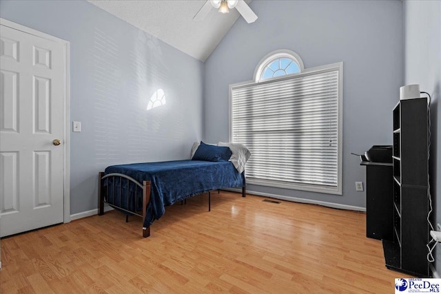 bedroom with lofted ceiling, light hardwood / wood-style floors, and ceiling fan