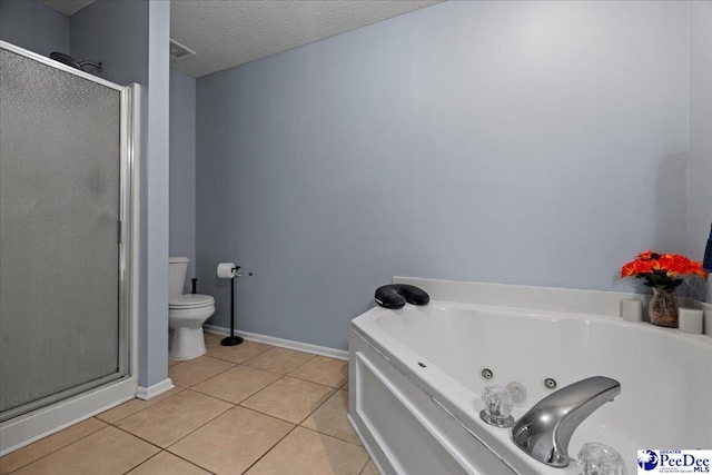 bathroom with tile patterned floors, toilet, a textured ceiling, and plus walk in shower