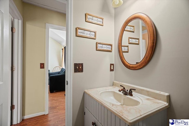 813 Williams St, Lake City, SC 29560 - bathroom featuring vanity, baseboards, and wood finished floors