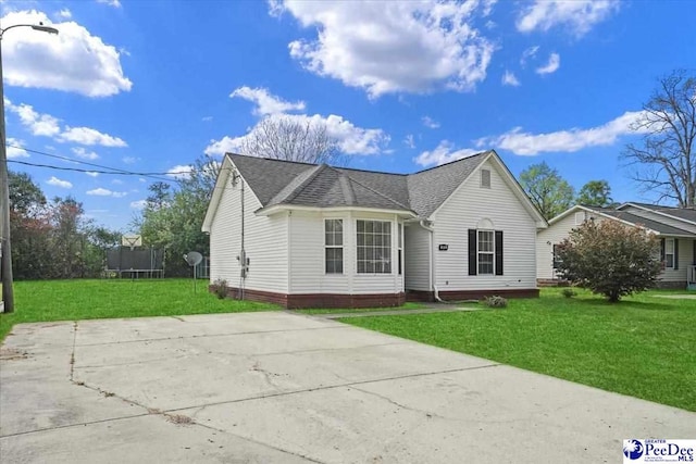 813 Williams St, Lake City, SC 29560 - view of front of property featuring a trampoline, roof with shingles, and a front lawn