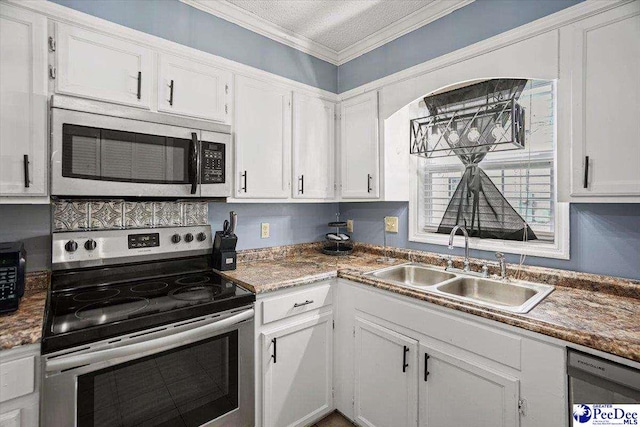 813 Williams St, Lake City, SC 29560 - kitchen with white cabinets, a sink, crown molding, and appliances with stainless steel finishes