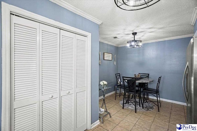813 Williams St, Lake City, SC 29560 - tiled dining room with baseboards, an inviting chandelier, ornamental molding, and a textured ceiling
