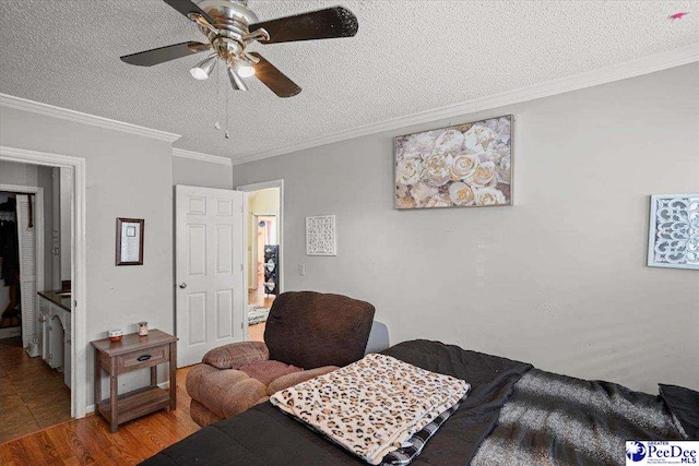 813 Williams St, Lake City, SC 29560 - bedroom with a textured ceiling, wood finished floors, ceiling fan, and ornamental molding