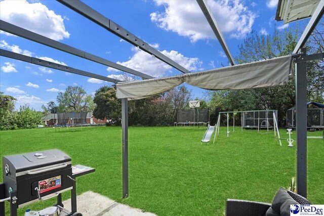 813 Williams St, Lake City, SC 29560 - view of yard featuring a playground and a trampoline