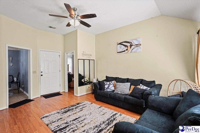 813 Williams St, Lake City, SC 29560 - living area featuring a textured ceiling, visible vents, wood finished floors, a ceiling fan, and vaulted ceiling