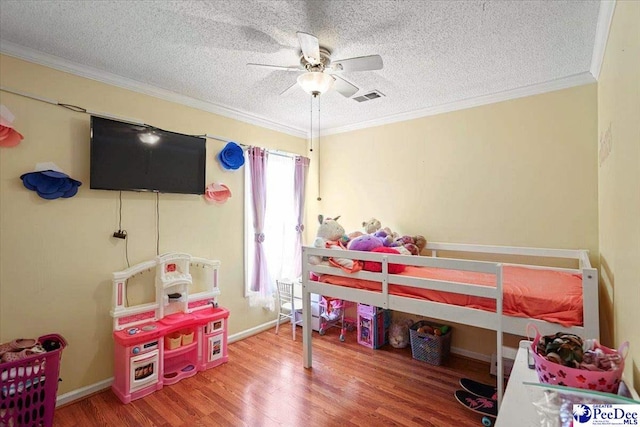 813 Williams St, Lake City, SC 29560 - bedroom with visible vents, wood finished floors, ornamental molding, and a textured ceiling