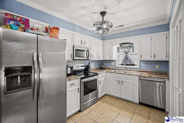 813 Williams St, Lake City, SC 29560 - kitchen featuring a sink, appliances with stainless steel finishes, white cabinets, ornamental molding, and an inviting chandelier